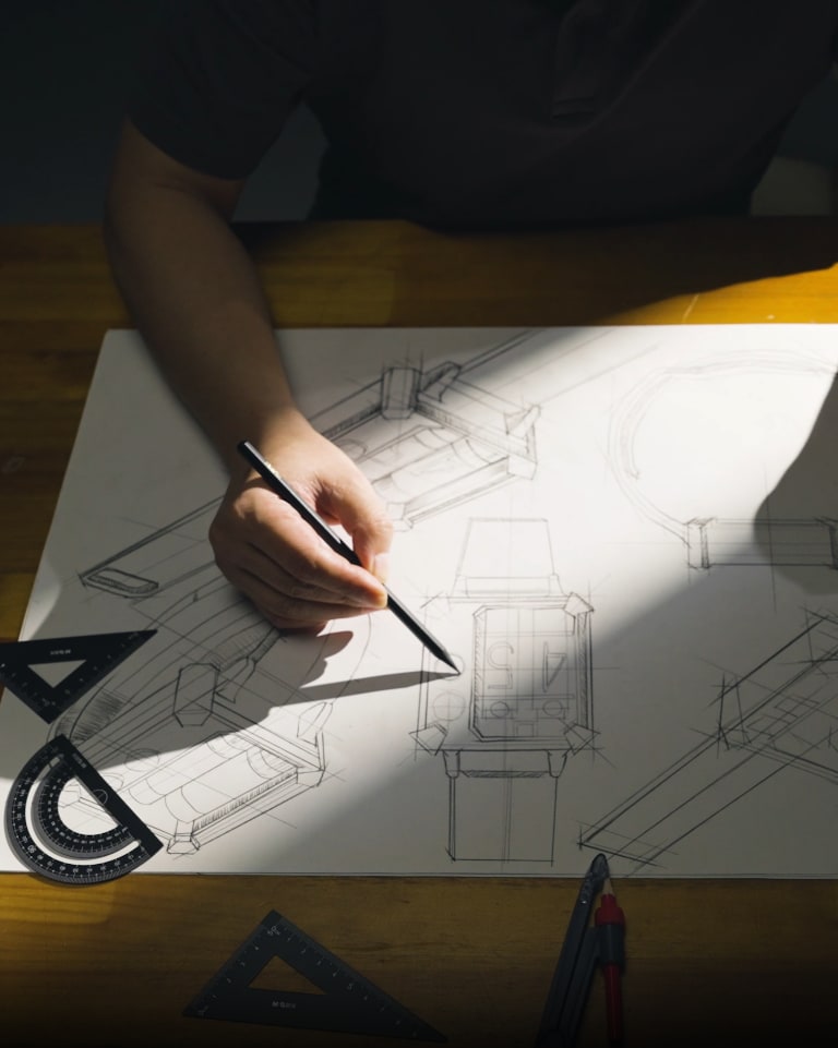 Atelier -- hand-drafted product sketches on a drafting table